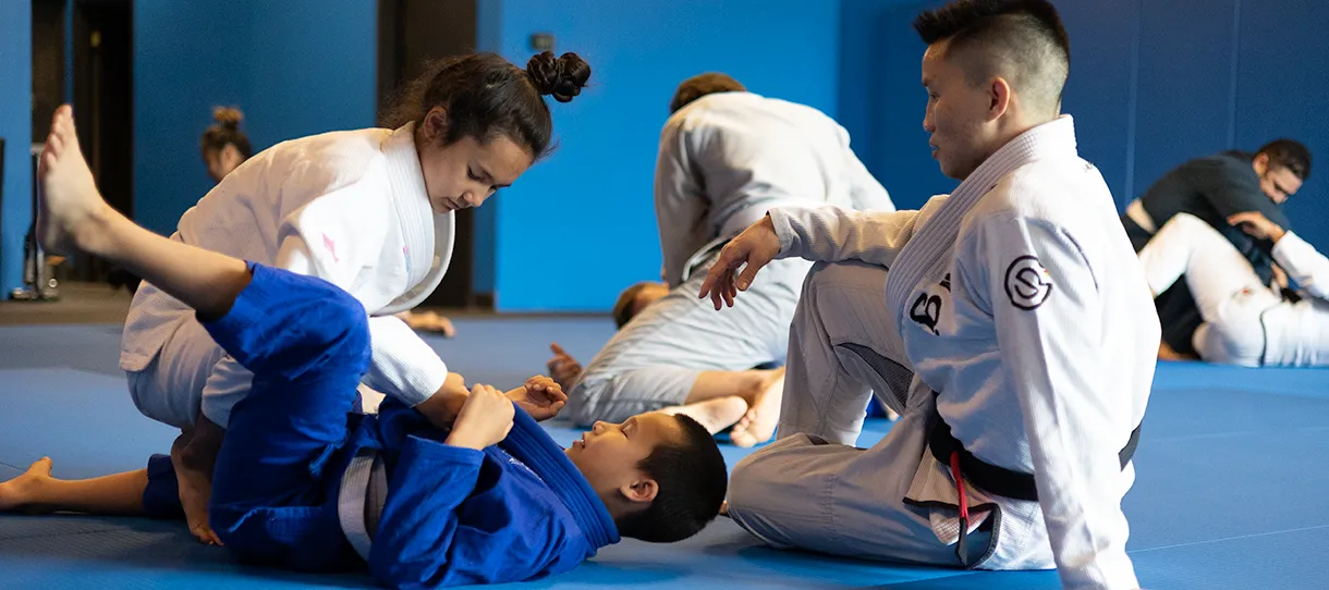 Guest instructor Ben Nguyen working with kids in Brazilian Jiu Jitsu