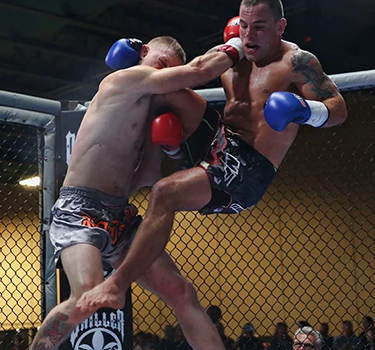 Head Instructor, Devin Turner, sweep his opponent at a pro Muay Thai fight.